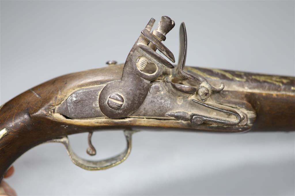 An 18th century Turkish flintlock pistol and an Eastern white metal powder flask